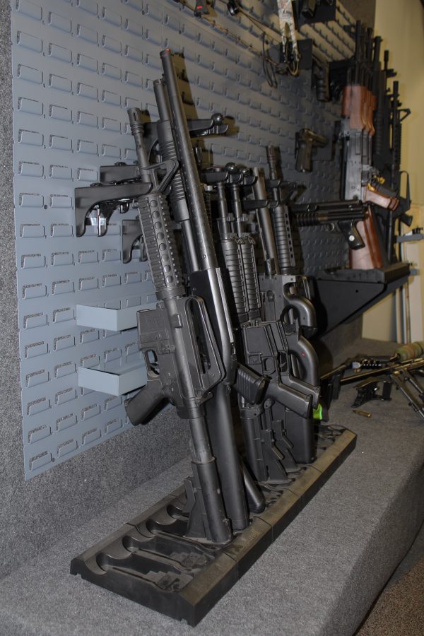 metal storage trays on custom gun wall